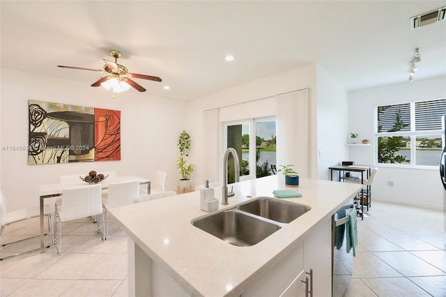 kitchen with a kitchen island with sink, a sink, visible vents, white cabinetry, and dishwasher