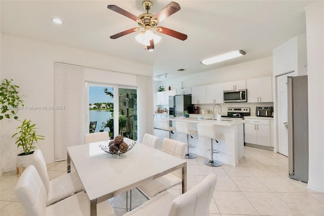 dining room featuring a ceiling fan and light tile patterned floors