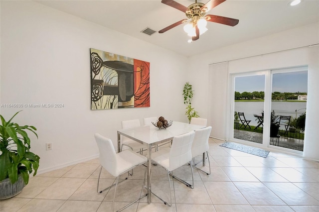 dining area featuring light tile patterned floors, baseboards, visible vents, and ceiling fan