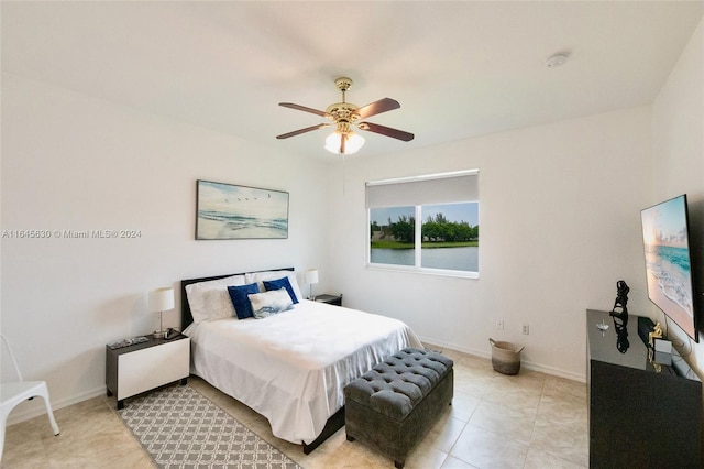 bedroom featuring ceiling fan, baseboards, and light tile patterned floors