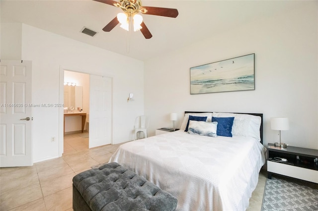 bedroom featuring visible vents, baseboards, ceiling fan, ensuite bathroom, and light tile patterned flooring