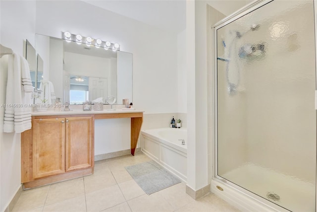 bathroom featuring vanity, a shower stall, a bath, and tile patterned floors