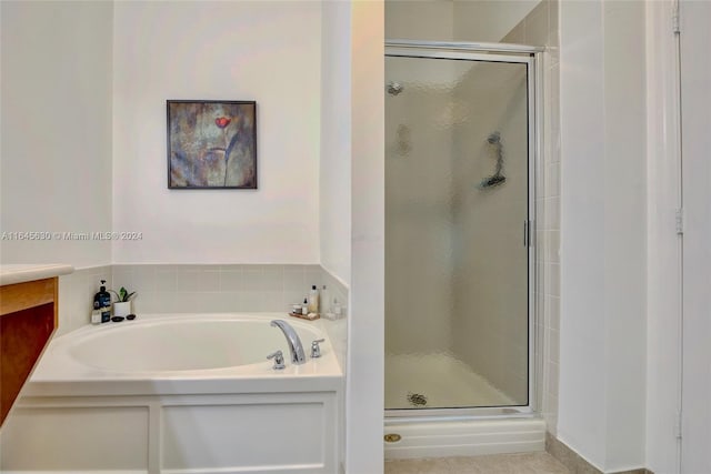 full bathroom with a garden tub and a shower stall