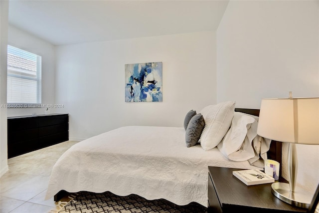 tiled bedroom featuring baseboards