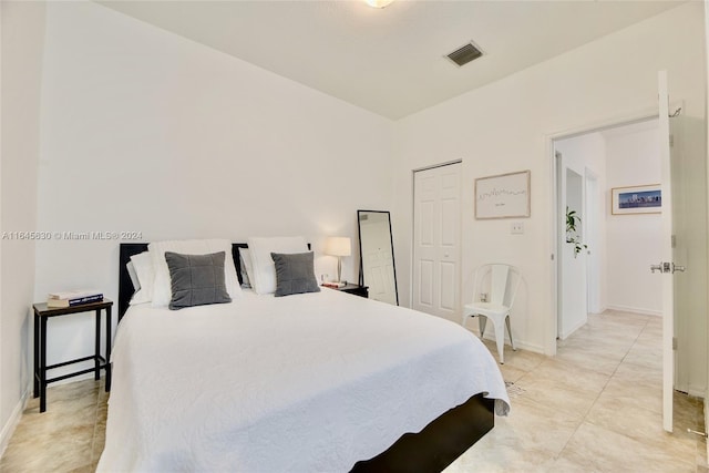 bedroom featuring light tile patterned floors, visible vents, and baseboards