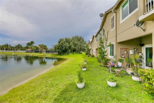 surrounding community featuring a yard and a water view