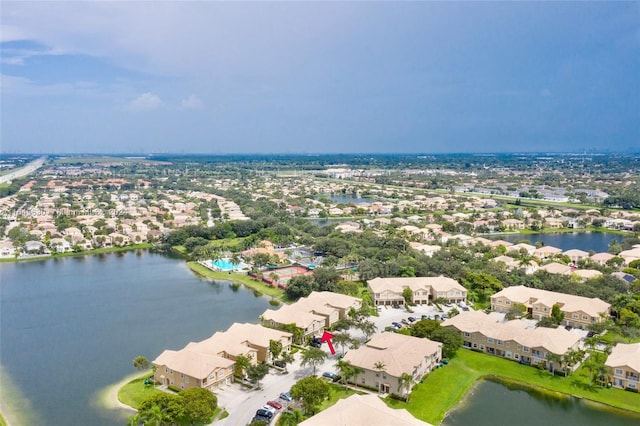 drone / aerial view with a water view and a residential view