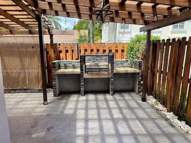 view of patio with a pergola and exterior kitchen