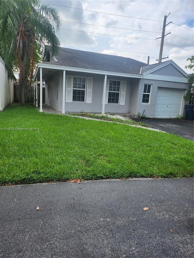 ranch-style house featuring a garage and a front lawn