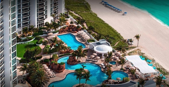 birds eye view of property with a view of the beach and a water view