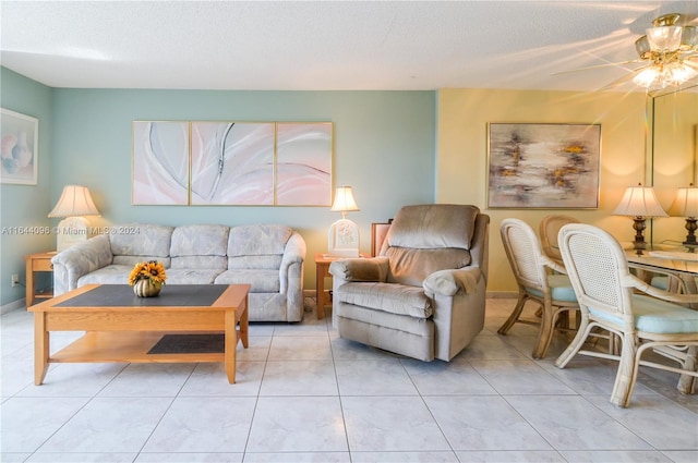 tiled living room with ceiling fan and a textured ceiling