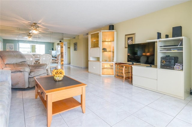 living room featuring light tile patterned floors and ceiling fan