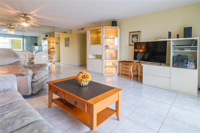 tiled living room with ceiling fan