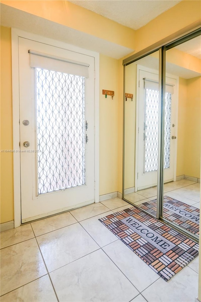 doorway featuring light tile patterned flooring