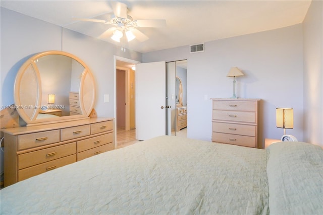 bedroom with a closet, ceiling fan, and light tile patterned floors