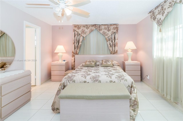 bedroom with ceiling fan and light tile patterned flooring