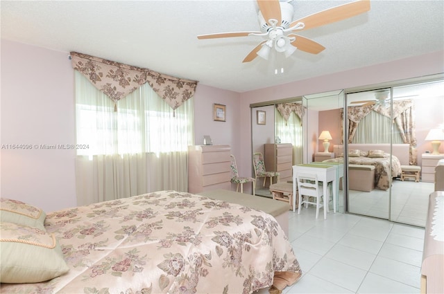 tiled bedroom featuring a textured ceiling, a closet, and ceiling fan