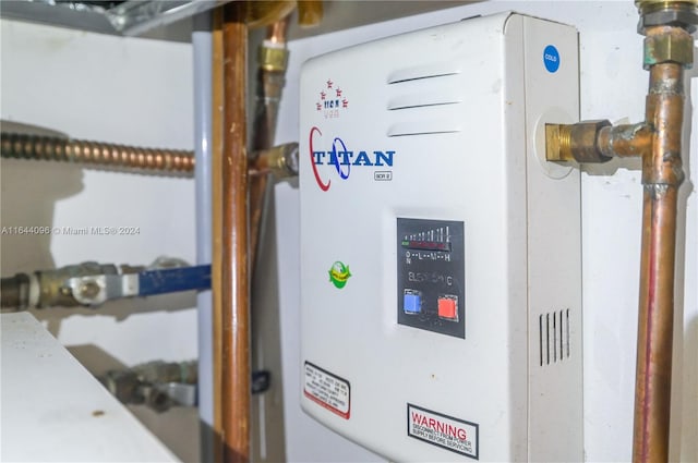 utility room featuring water heater