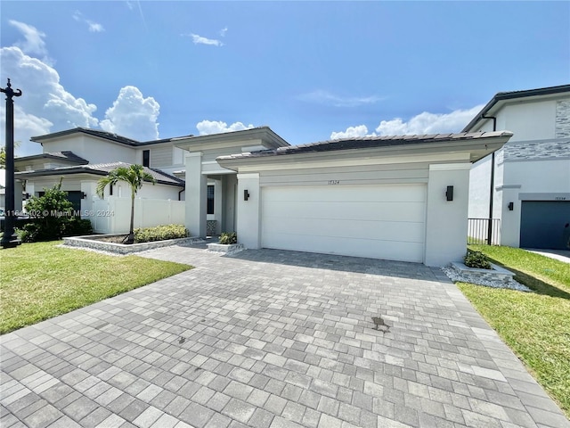 view of front of home featuring a garage and a front yard