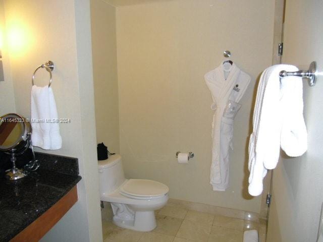 bathroom featuring toilet, tile patterned floors, and vanity