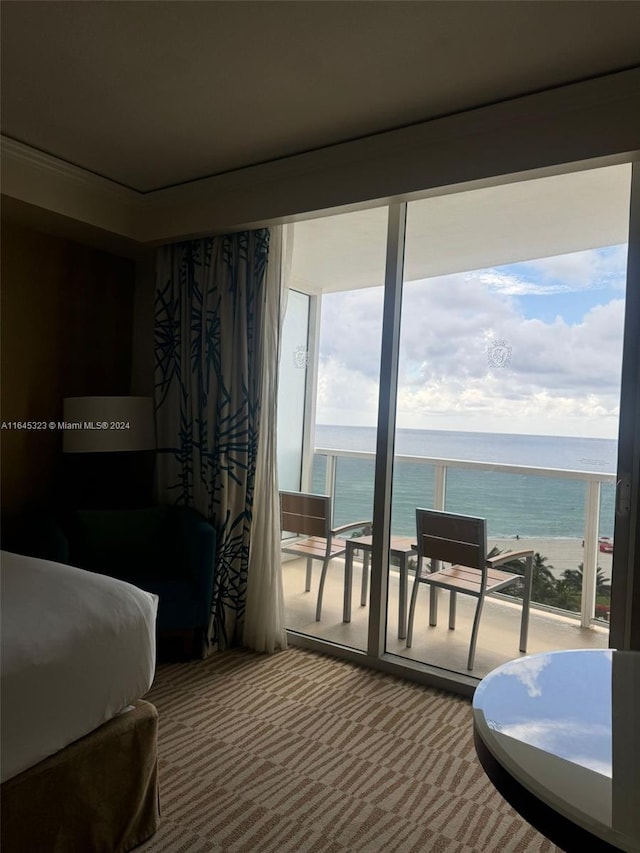 carpeted bedroom featuring multiple windows and a water view