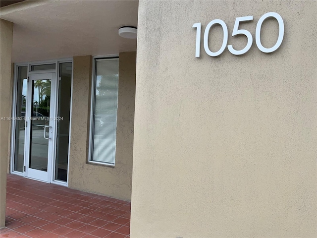 property entrance with stucco siding