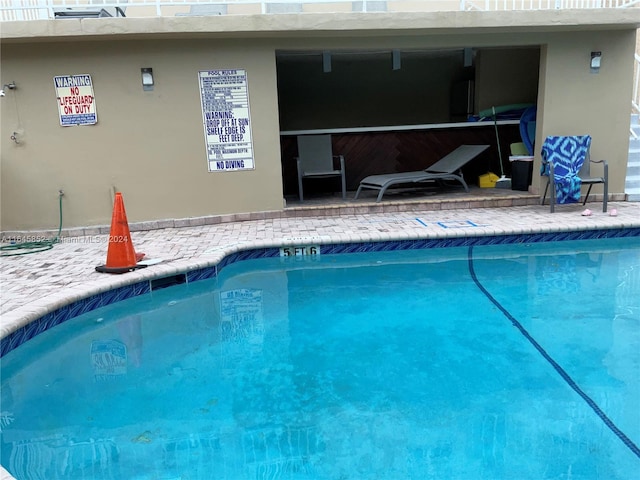 view of swimming pool with a patio area