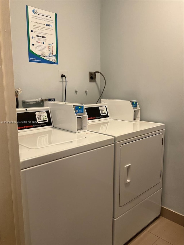 clothes washing area featuring independent washer and dryer and light tile patterned floors