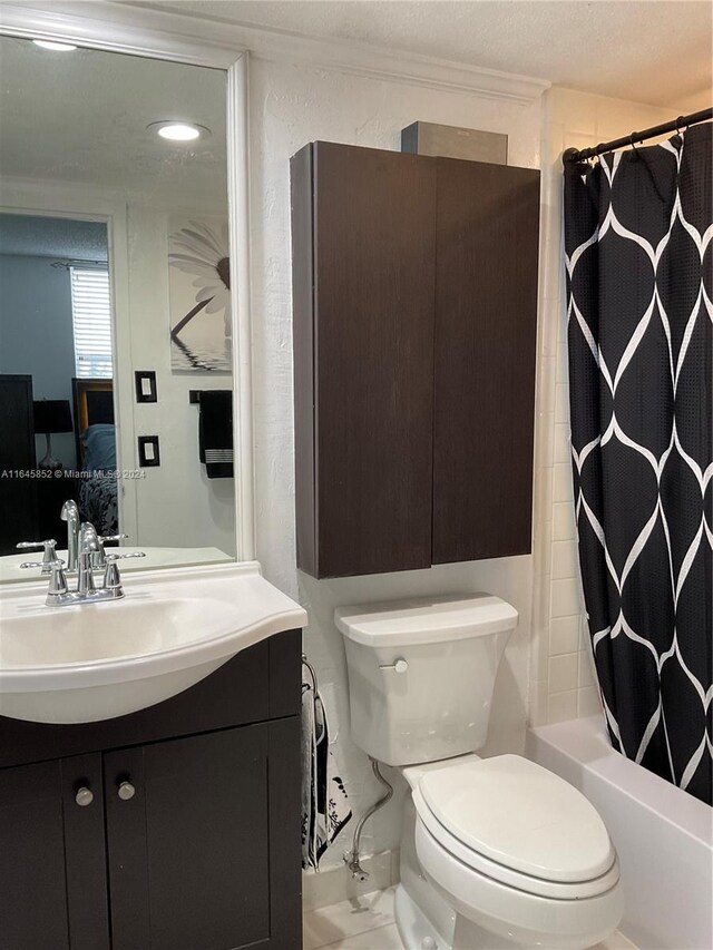 full bathroom featuring vanity, shower / bath combo, and toilet