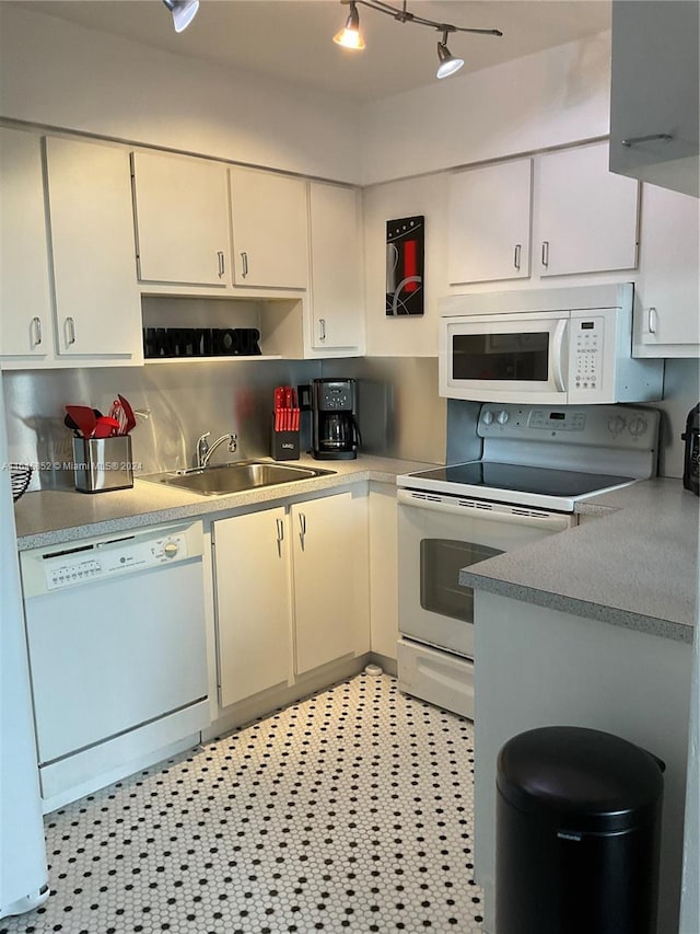 kitchen featuring sink, white appliances, light tile patterned flooring, and track lighting