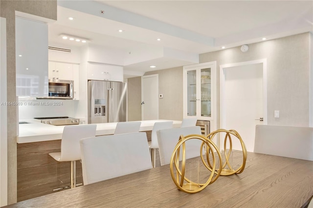 kitchen featuring light wood-type flooring, appliances with stainless steel finishes, and white cabinets