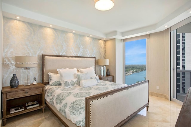 bedroom with light tile patterned flooring and a water view