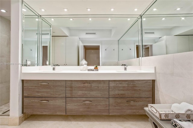 bathroom featuring a shower, tile walls, tile patterned floors, and vanity