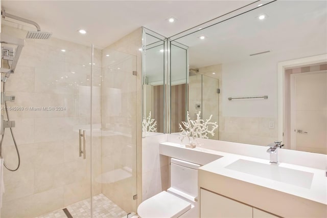 bathroom with a shower with door and vanity