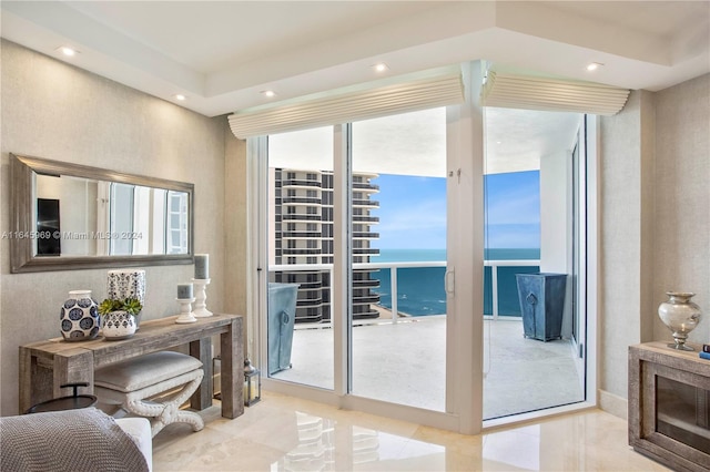 doorway featuring plenty of natural light, a water view, and light tile patterned floors