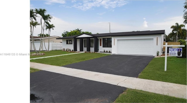 view of front facade featuring a front yard and a garage