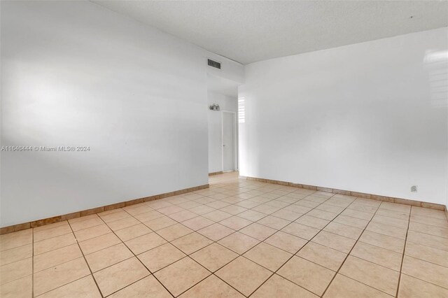 spare room with light tile patterned floors