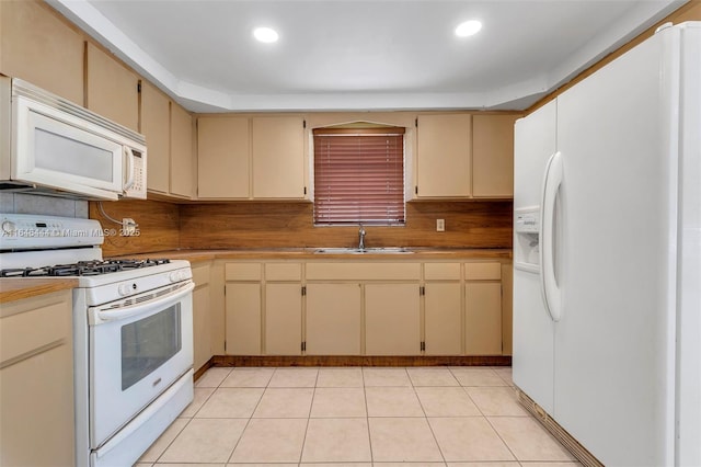 4296 E 9th Ln, Hialeah, FL 33013 - kitchen with white appliances, cream cabinets, light tile patterned floors, recessed lighting, and tasteful backsplash