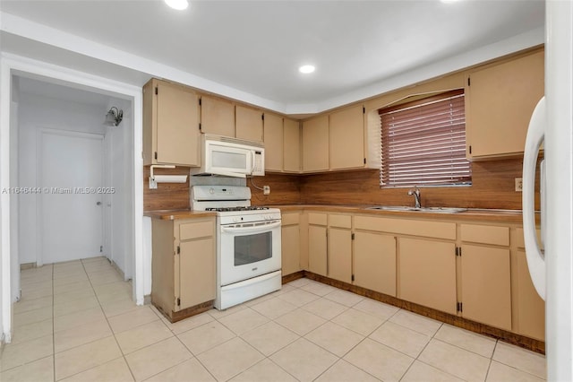 4296 E 9th Ln, Hialeah, FL 33013 - kitchen featuring white appliances, backsplash, recessed lighting, and cream cabinetry
