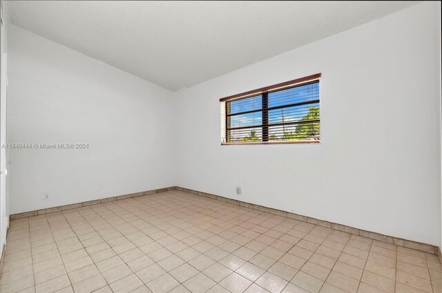 unfurnished room with light tile patterned floors