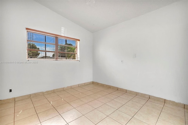 4296 E 9th Ln, Hialeah, FL 33013 - unfurnished room with lofted ceiling and light tile patterned floors