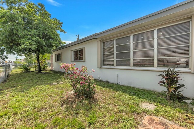 view of property exterior featuring a lawn