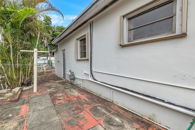 view of side of property featuring a patio area