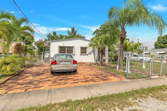 4296 E 9th Ln, Hialeah, FL 33013 - view of front of home with a gate and stucco siding