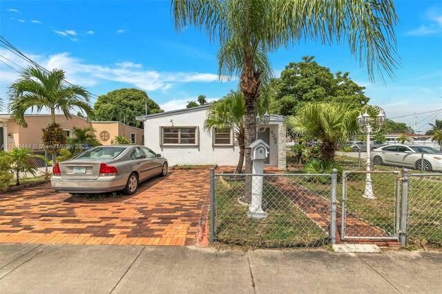 4296 E 9th Ln, Hialeah, FL 33013 - view of front facade with a fenced front yard, a gate, and stucco siding