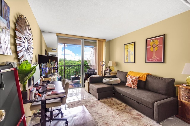 tiled living room with a textured ceiling and a wall of windows