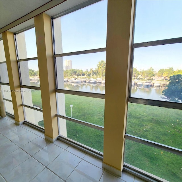 unfurnished sunroom with a water view and a wealth of natural light