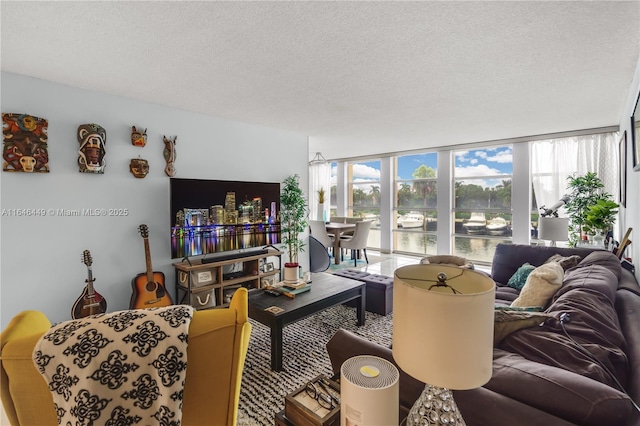 living room featuring a wall of windows and a textured ceiling