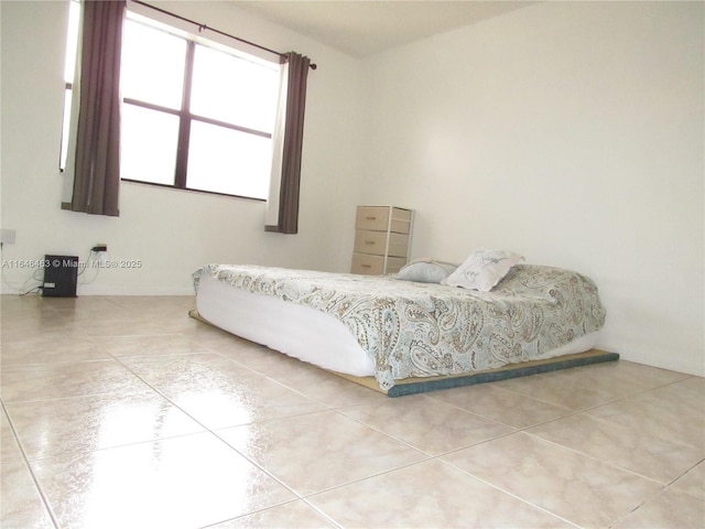 bedroom featuring light tile patterned floors