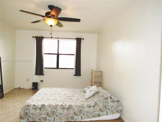 tiled bedroom with ceiling fan and a closet